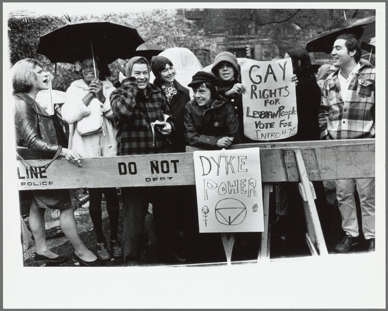 a crowd of protestors holding signs for gay rights